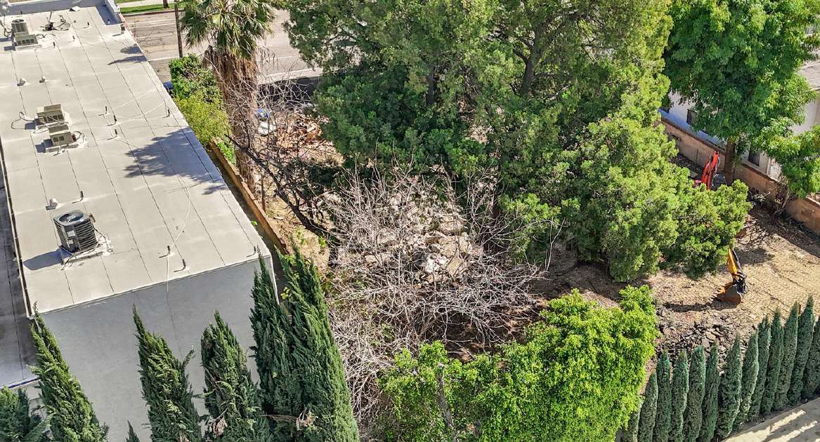 Aerial over the adjacent building toward the rear of the site