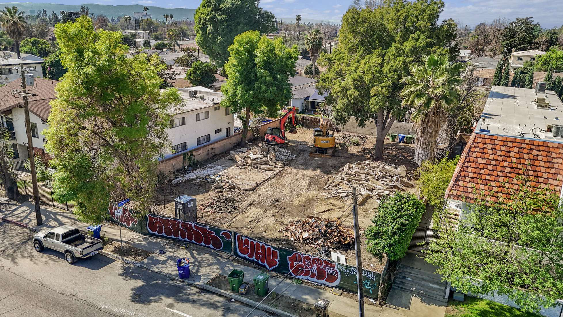 Aerial of the cleared site at 6901 Woodman Ave with demolition underway
